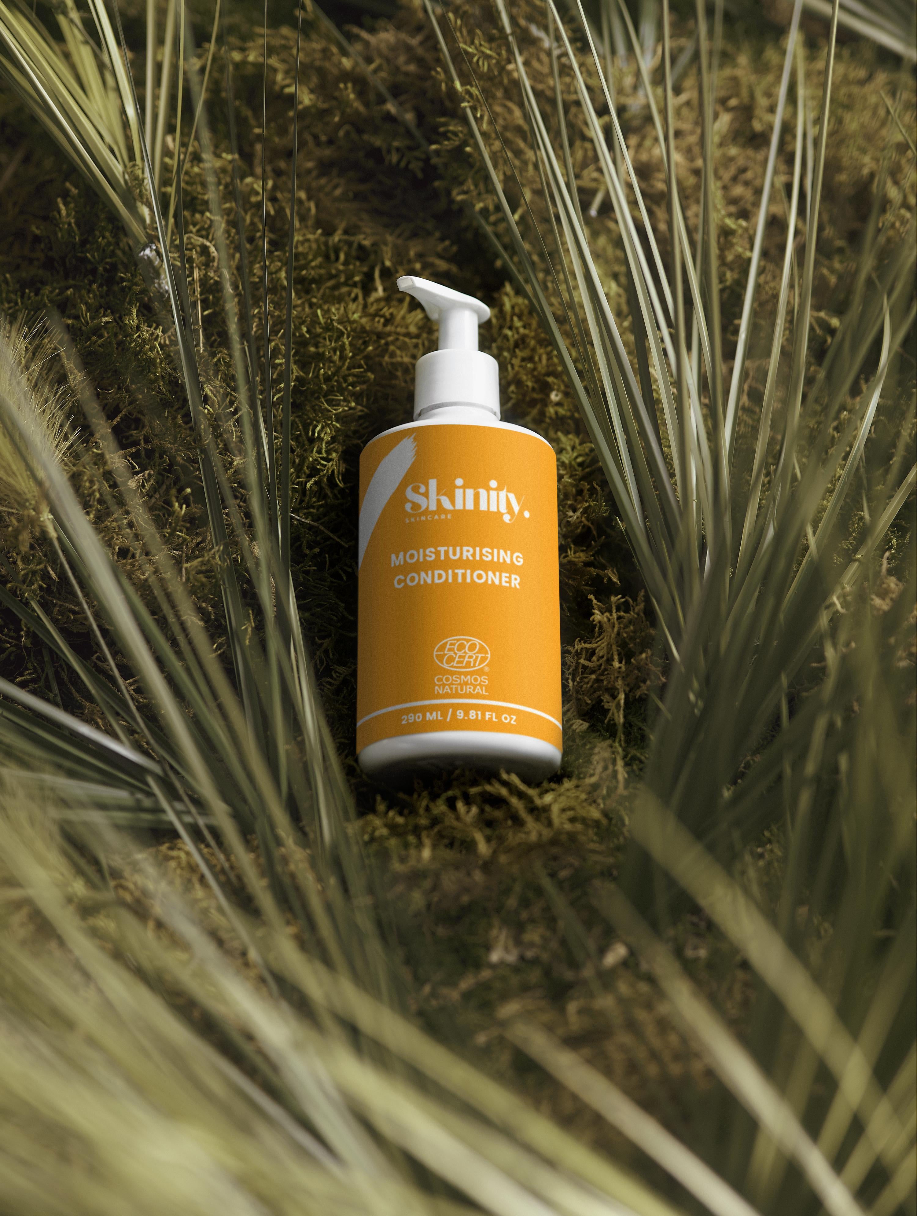Moisturising Conditioner for all Hair Types bottle on natural foliage background