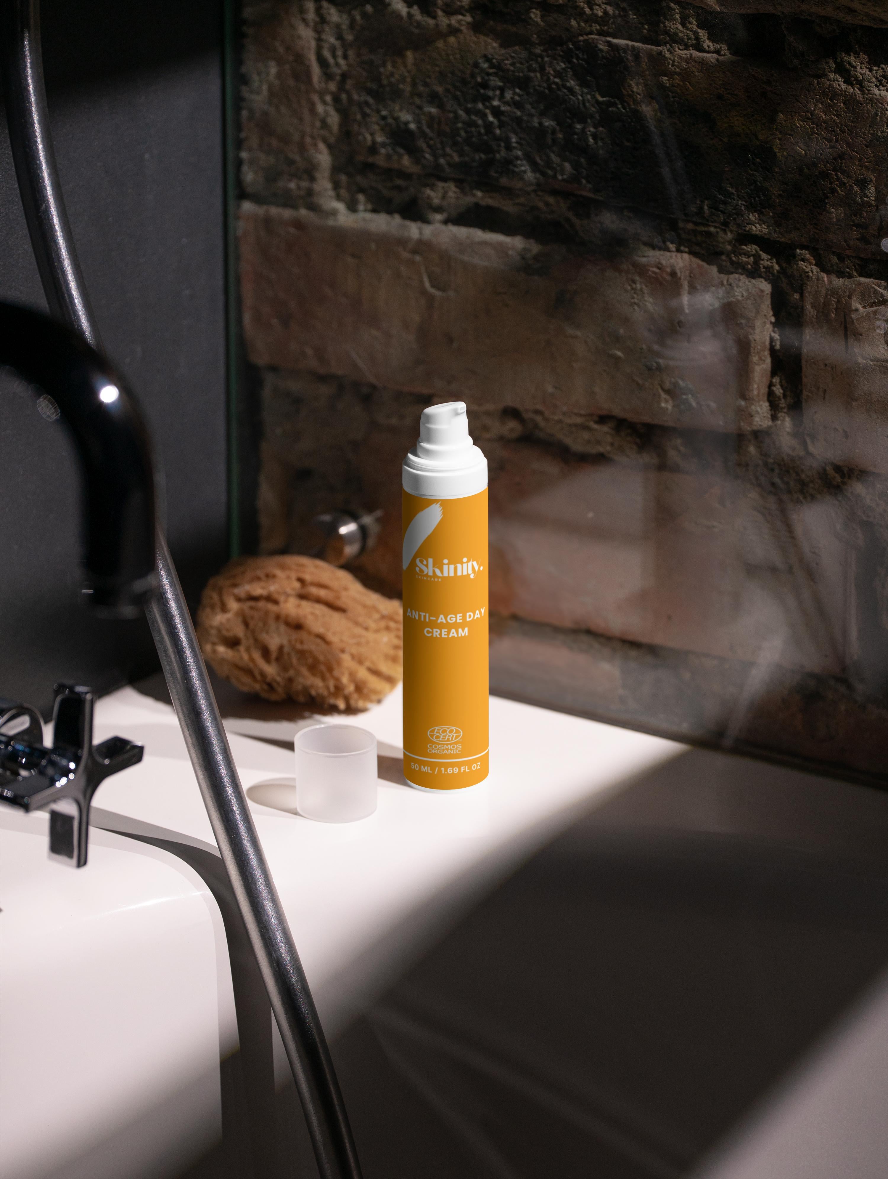 Anti-Age Day Cream For All Skin on a bathroom counter next to a natural sponge.