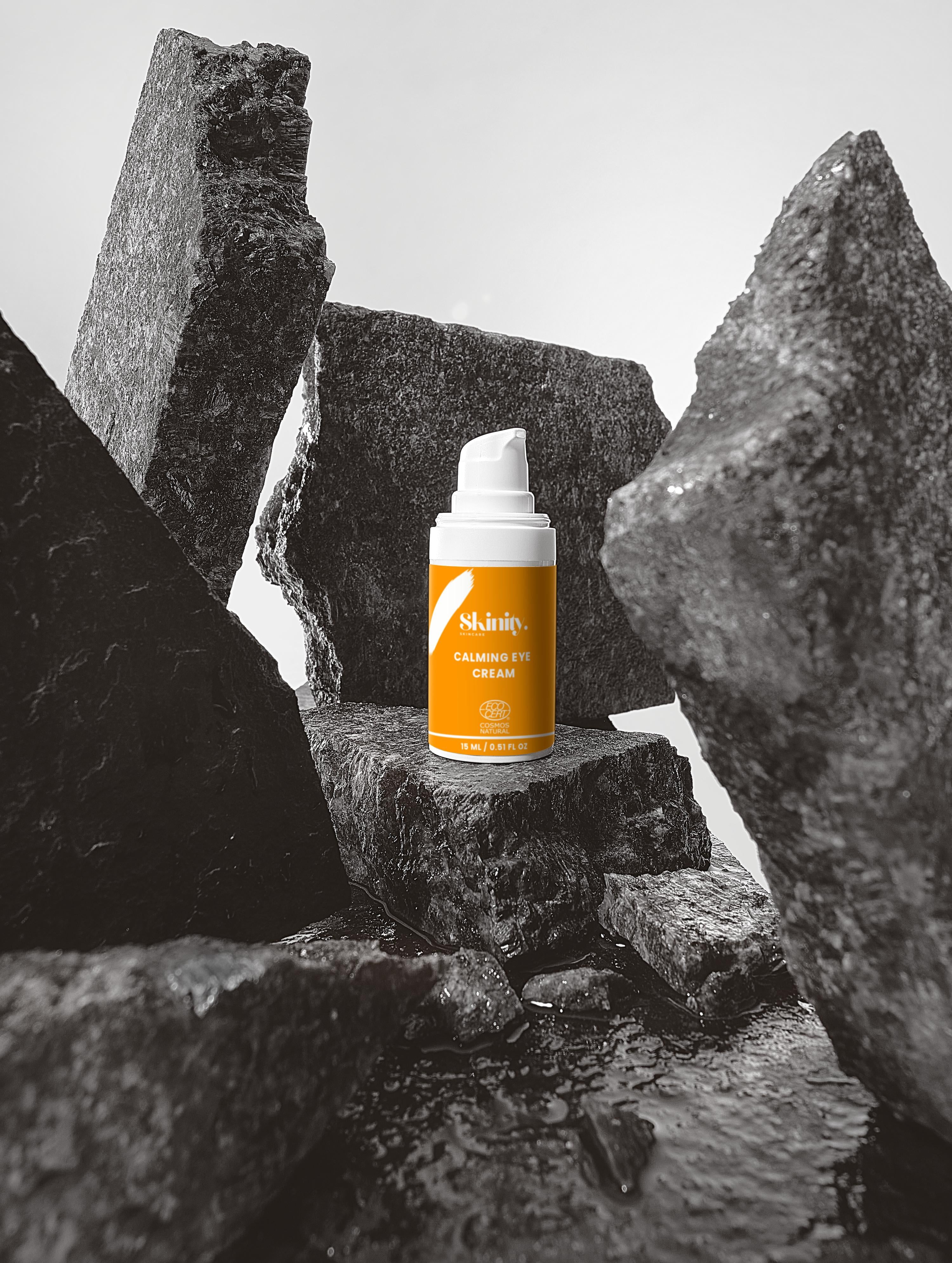 Calming Eye Cream for All Types on display among textured rocks, emphasizing soothing skincare.