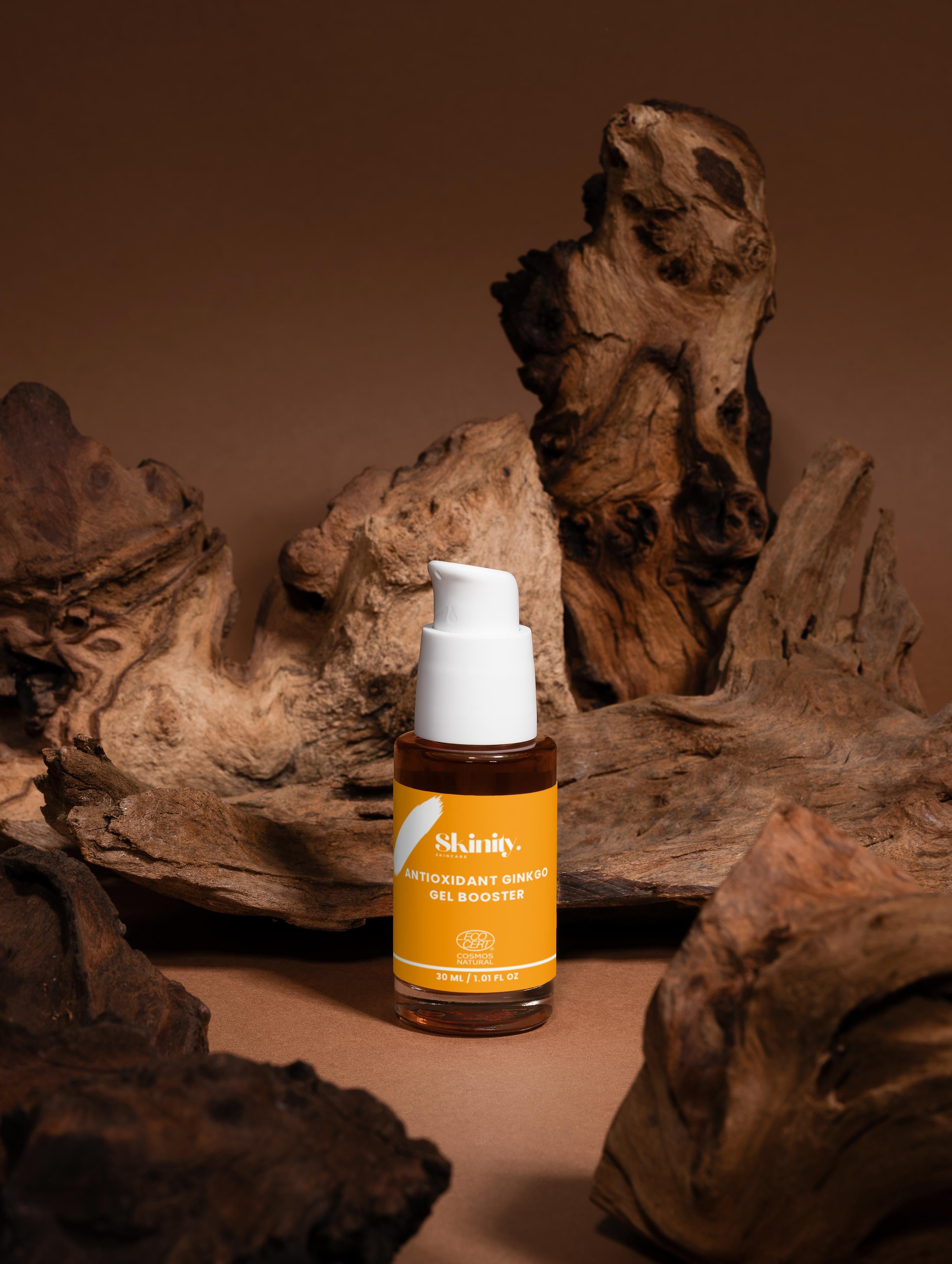 Antioxidant Ginkgo Gel Booster bottle on a wooden background, promoting skin rejuvenation and protection.