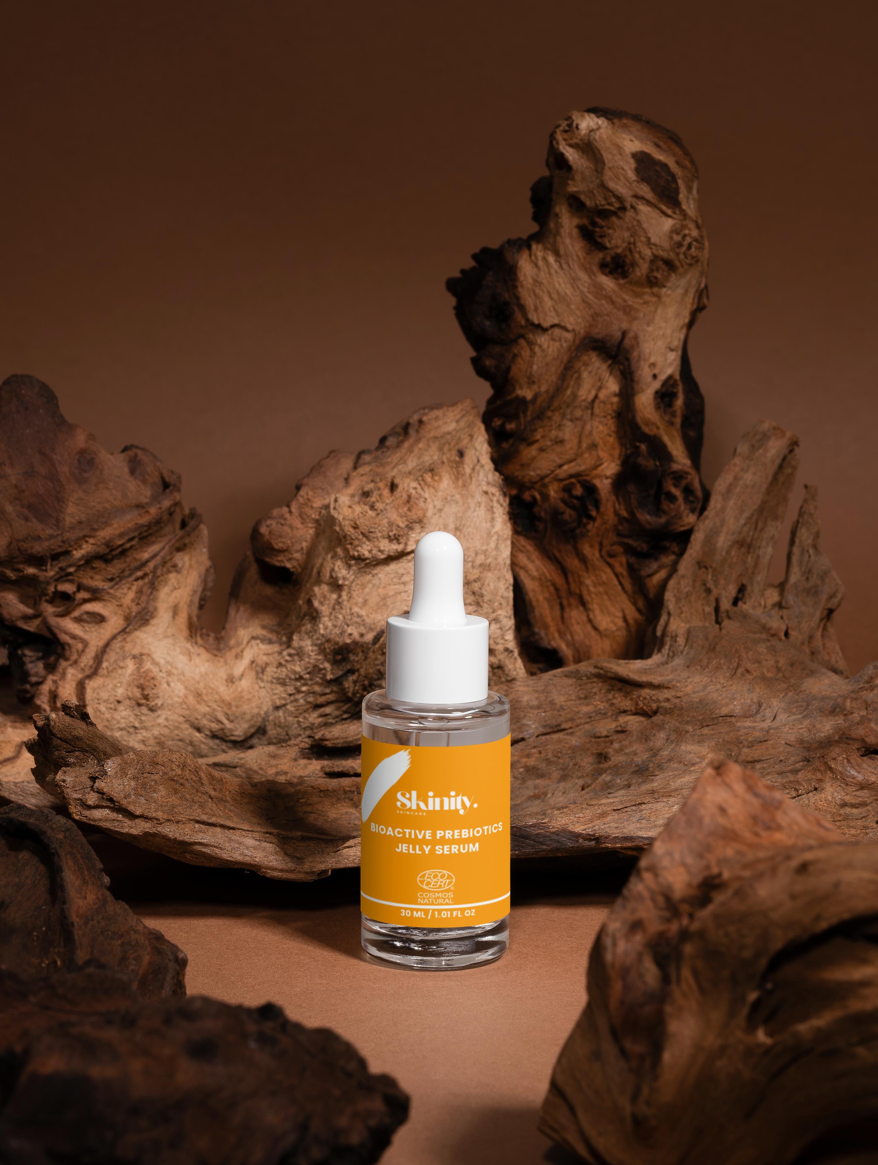 Bioactive Prebiotics Jelly Serum bottle displayed on natural wood background.