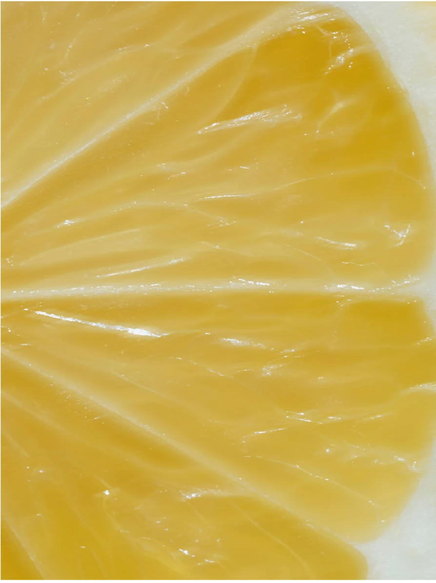 Close-up of a lemon slice showing its juicy, vibrant flesh, showcasing the fresh and zesty color.