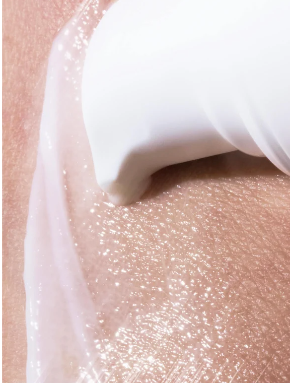 Brightening Eye Cream for All skincare being applied to skin, showcasing its smooth texture and hydration.