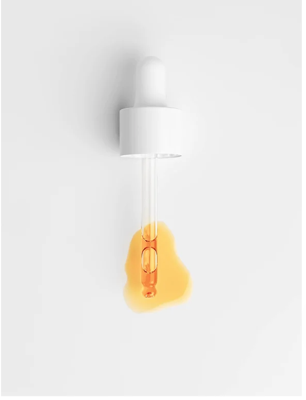 All-In-One Facial Oil For All Skin in a dropper with orange oil against a white background.