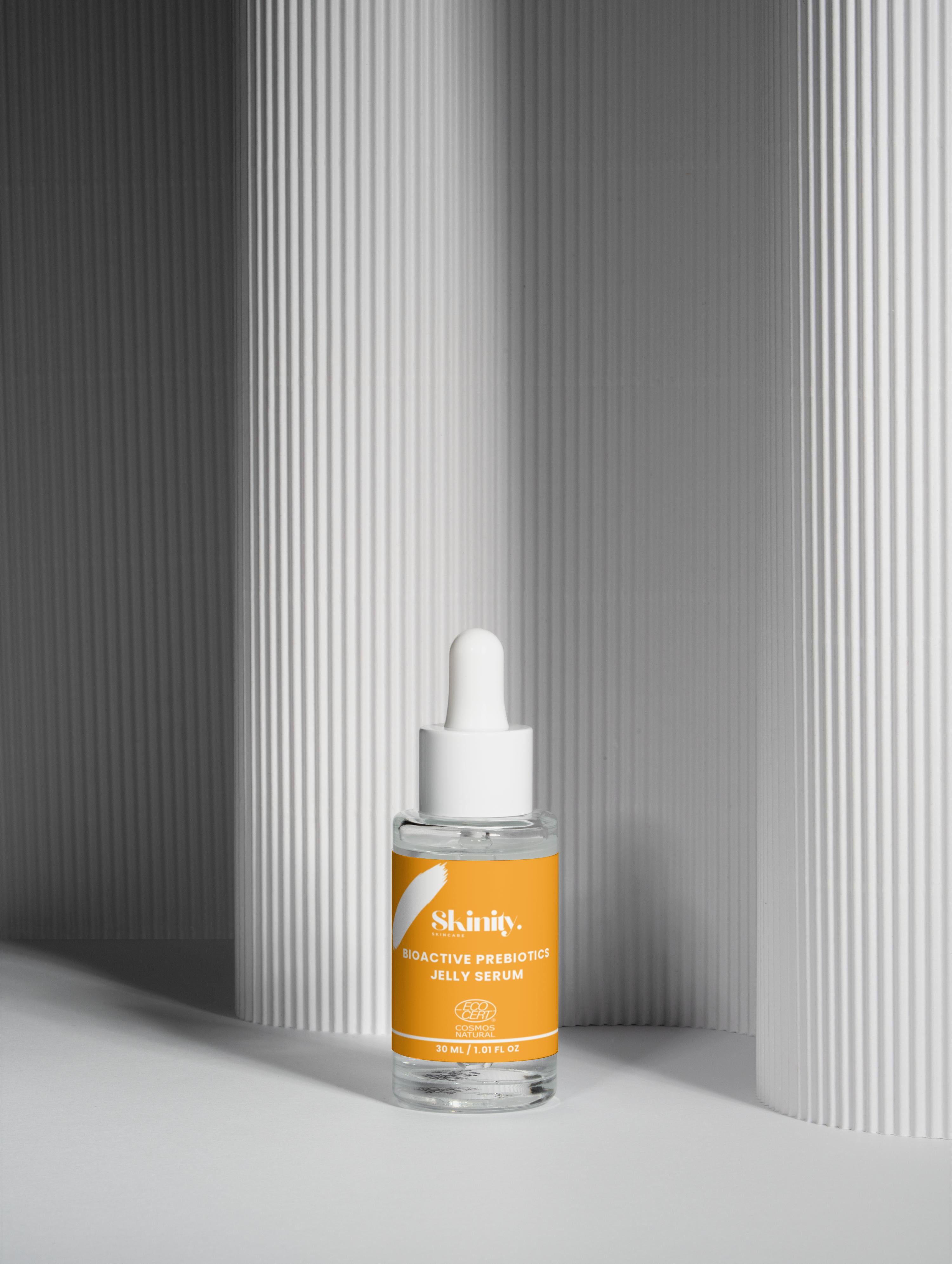 Bioactive Prebiotics Jelly Serum bottle on a textured background for skincare hydration.