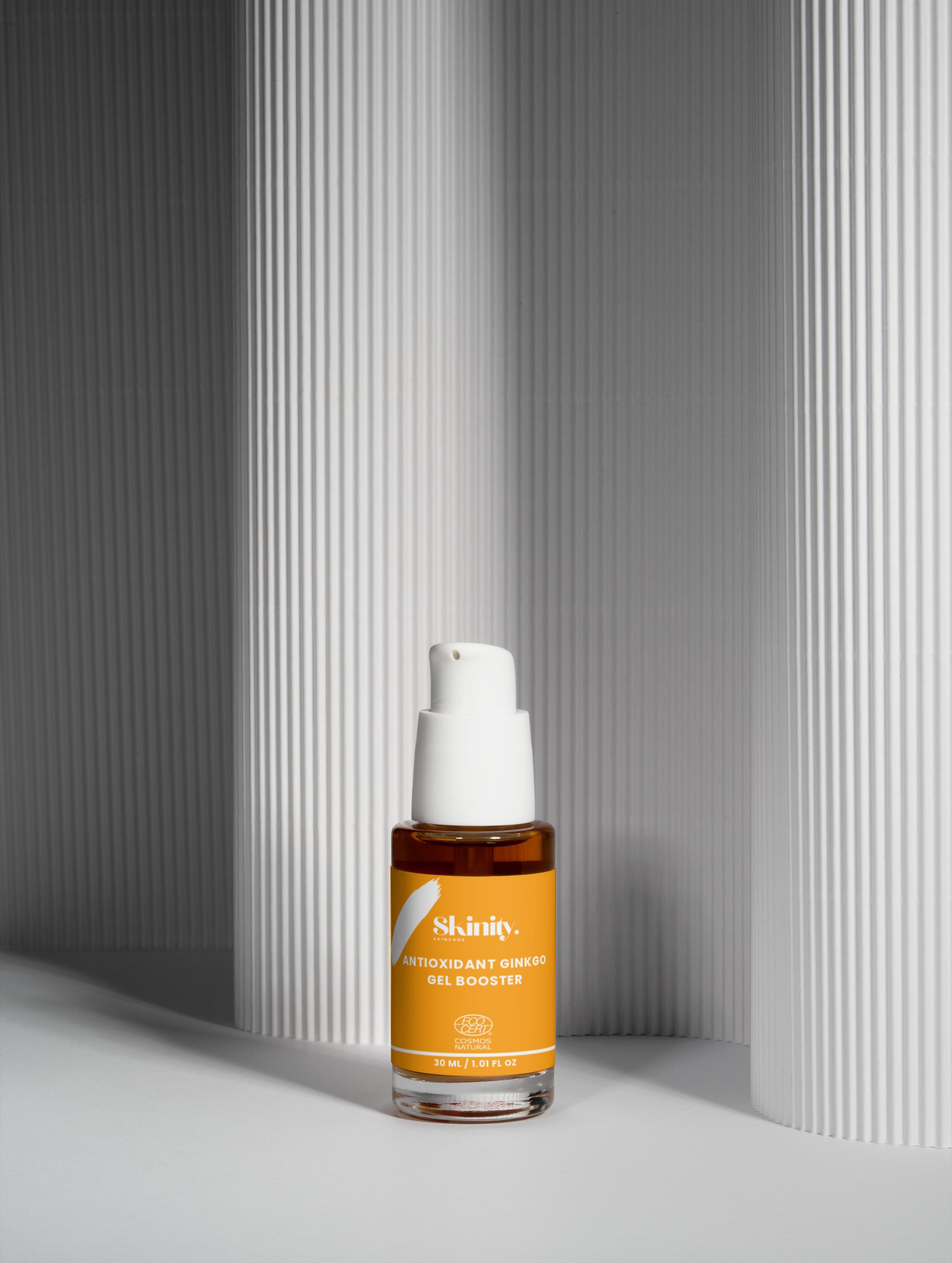 Antioxidant Ginkgo Gel Booster in a sleek bottle on a minimalist background for skin rejuvenation.