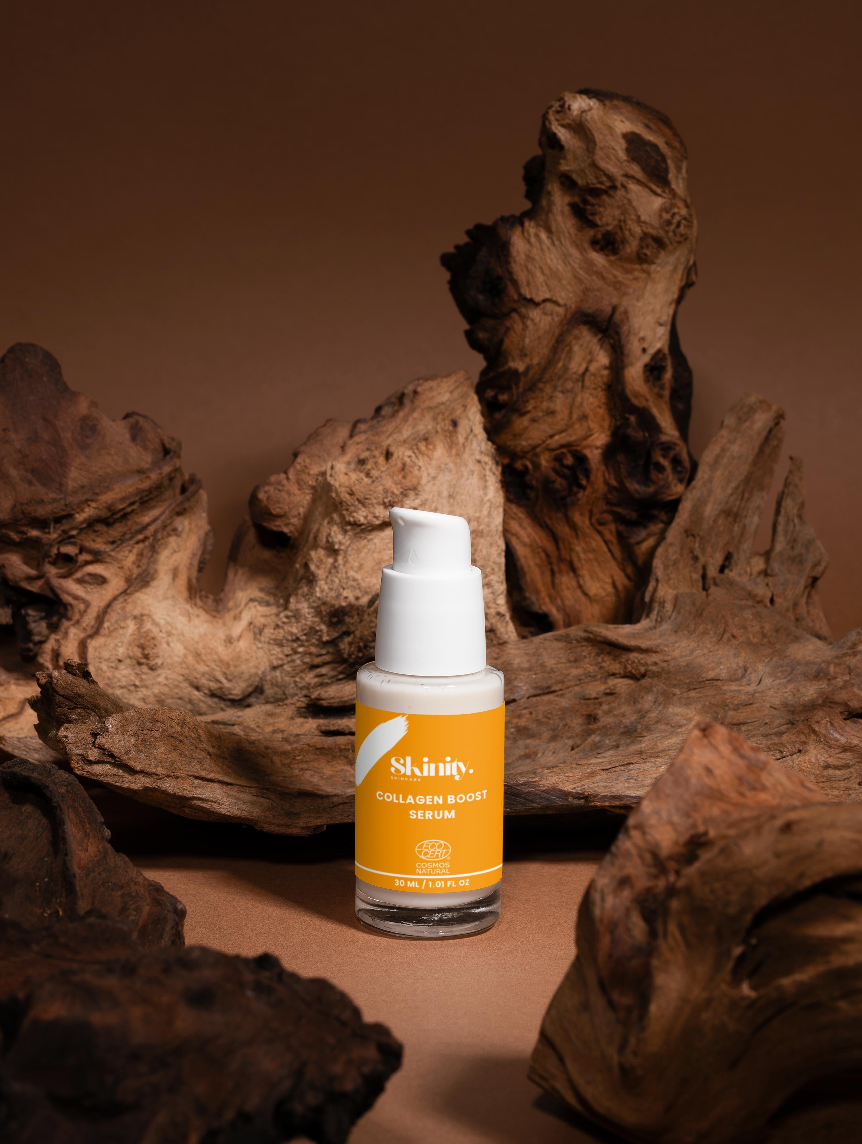 Collagen Boost Serum for All Skin showcased among natural wood elements, emphasizing hydration and youthful glow.