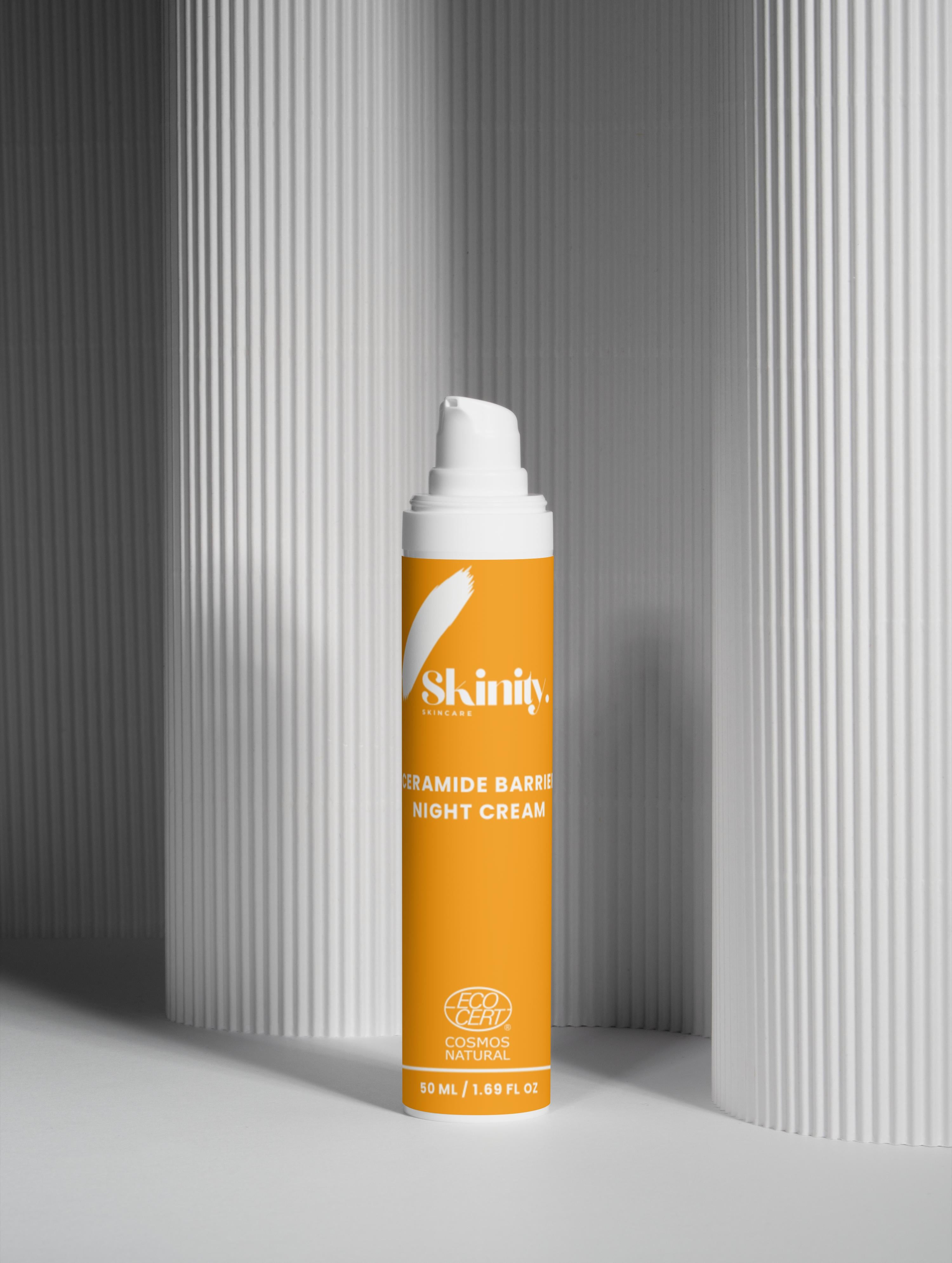 Ceramide Barrier Night Cream for all Skin Types in a sleek orange bottle against a minimalist background.