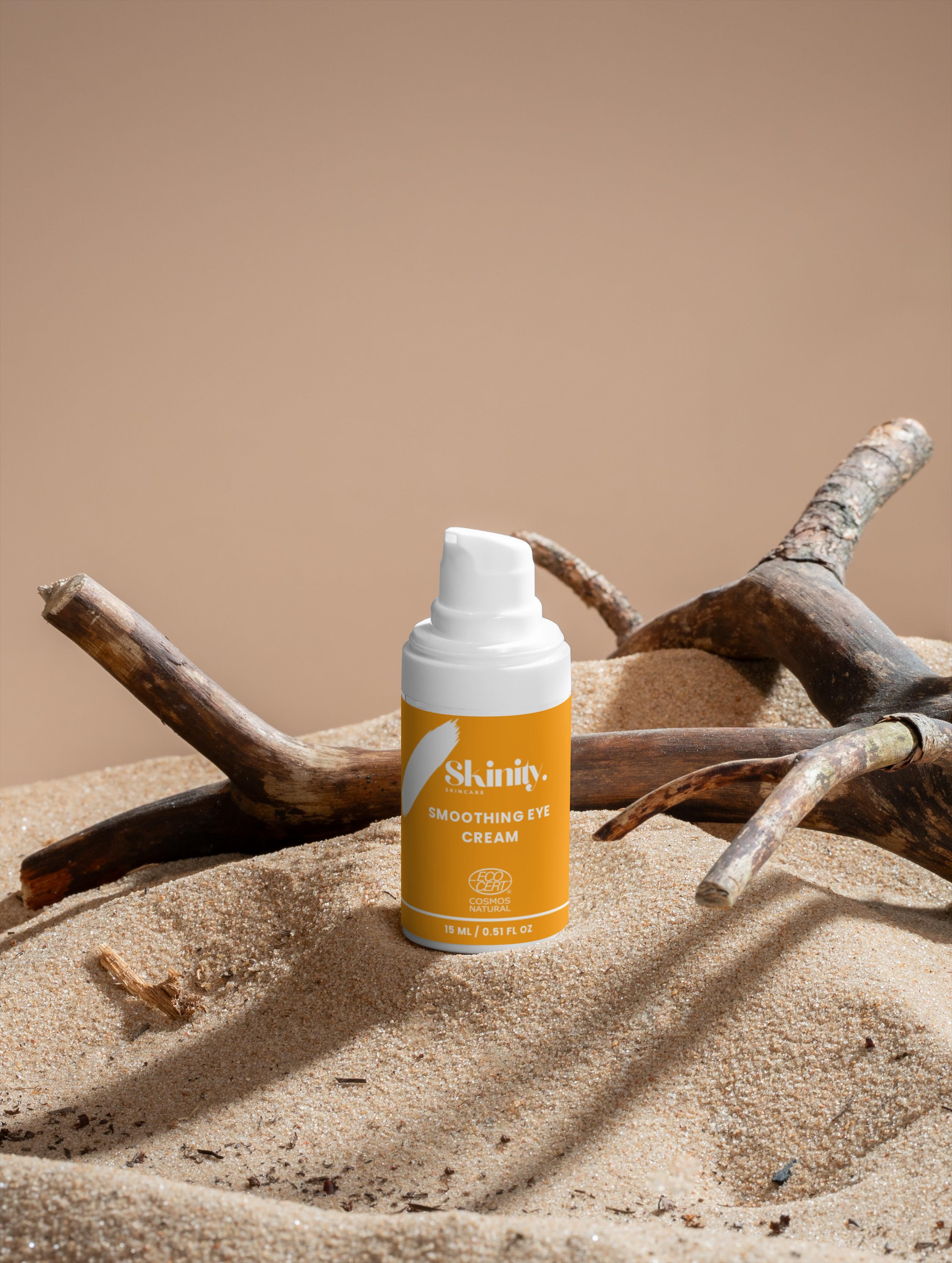 Smoothing eye cream bottle displayed on sand with driftwood for skincare hydration and firmness.